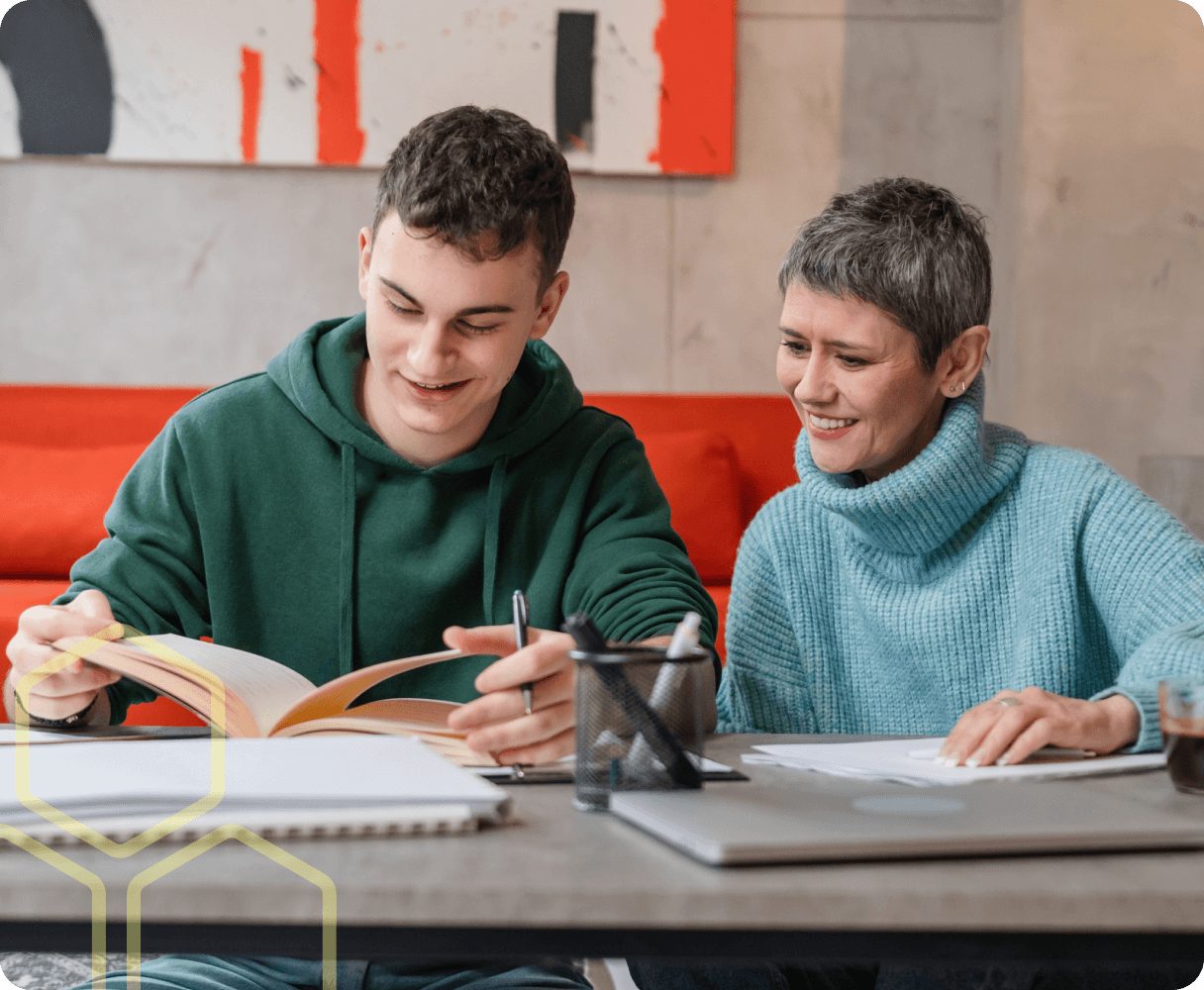 Image of a young person working with a teacher