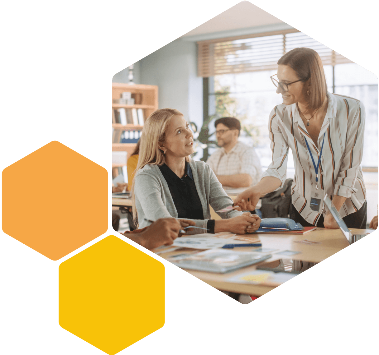 Image of a teacher talking to a young person in a classroom