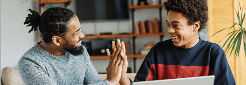 Student and teacher high-fiving